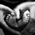 Hands making a heart around baby feet