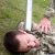 Agonised soldier pinned by aluminium baseball bat