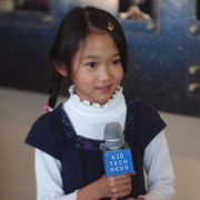Little girl (East Asian) holding microphone