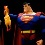 Superman toy eye-to-eye with rubber chicken