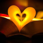 Pages of a book curved to form a warmly lit heart